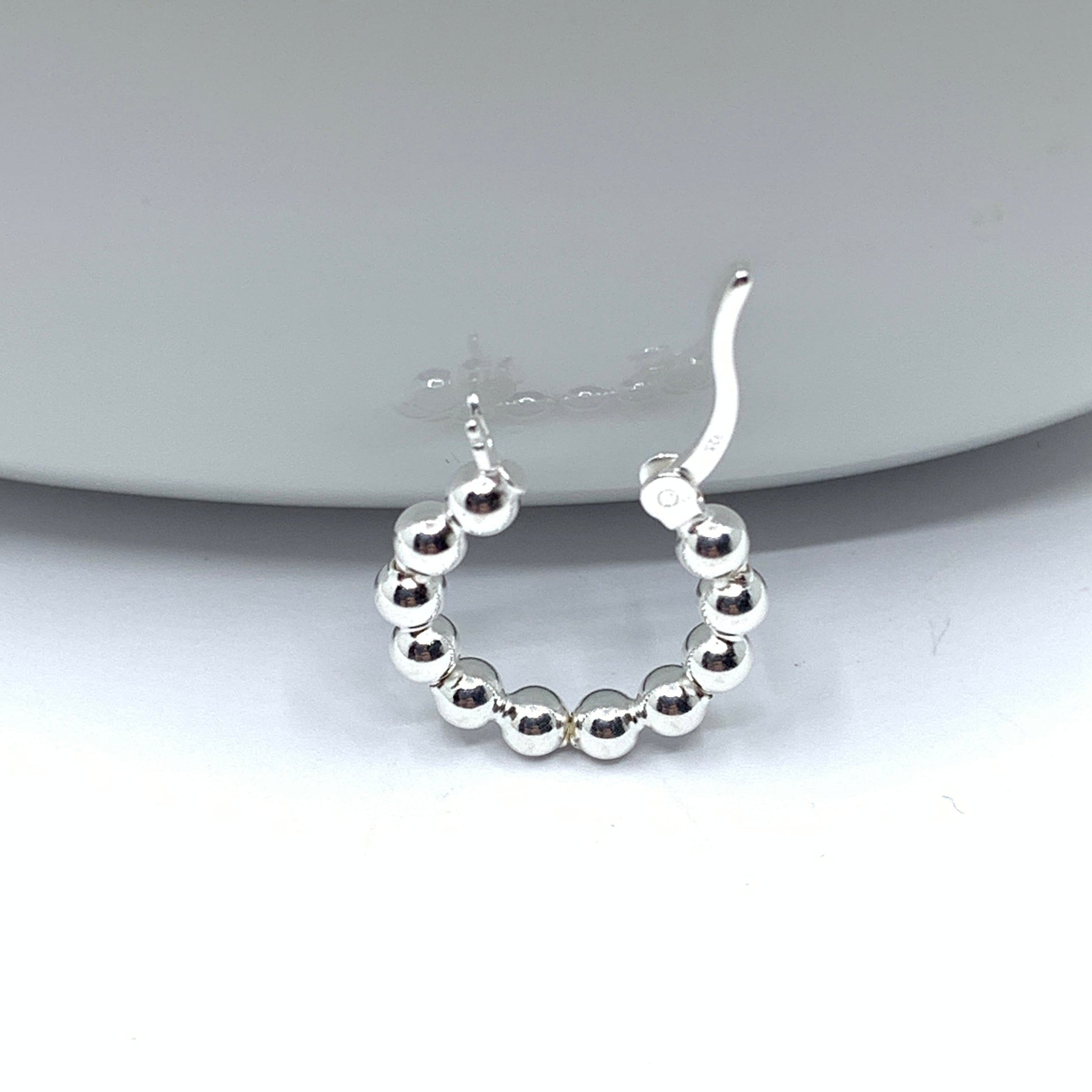 Open loop of ball beaded hoop earrings