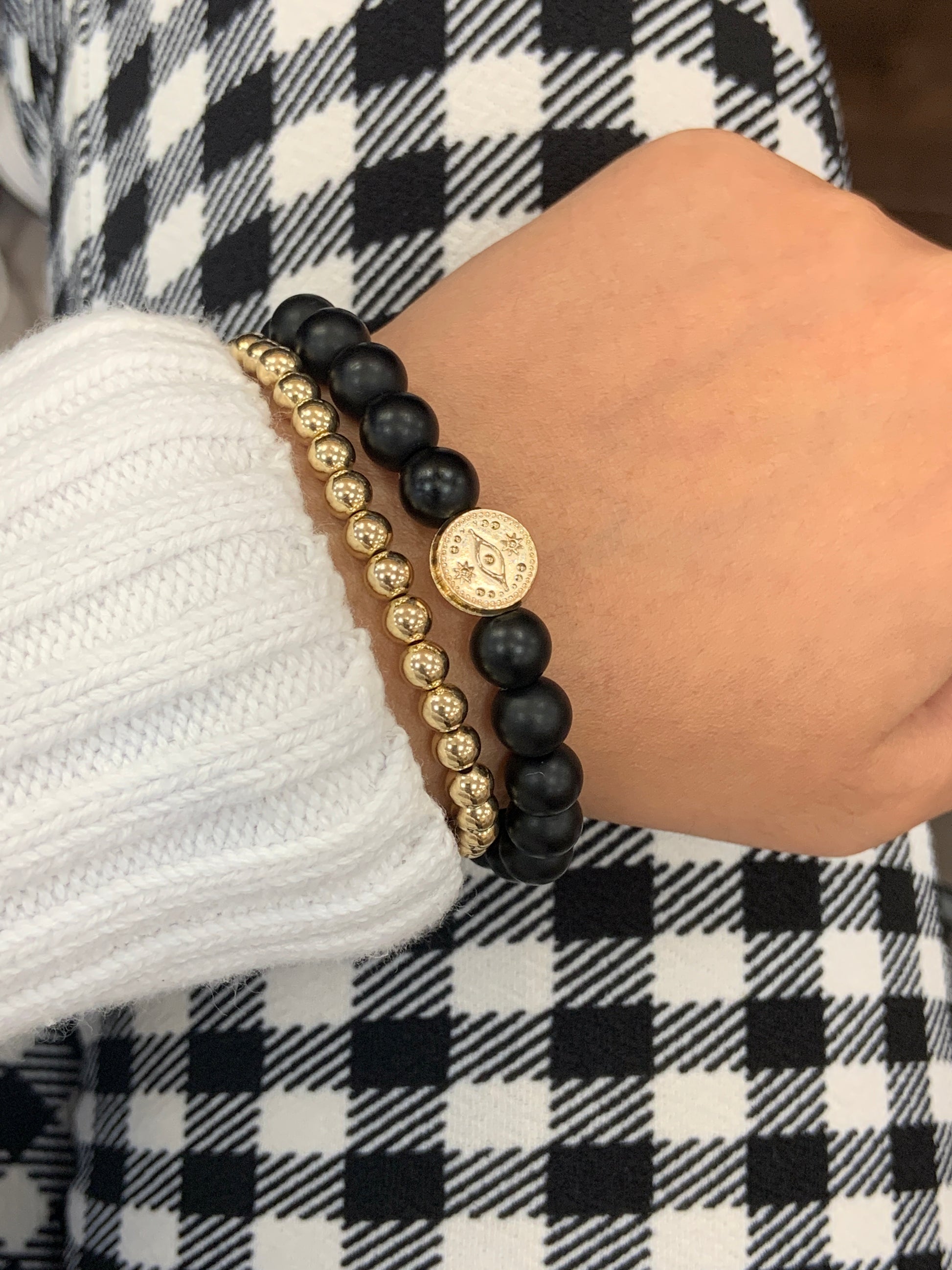 Frosted onyx evil eye bracelet layered with 14k gold filled bracelet