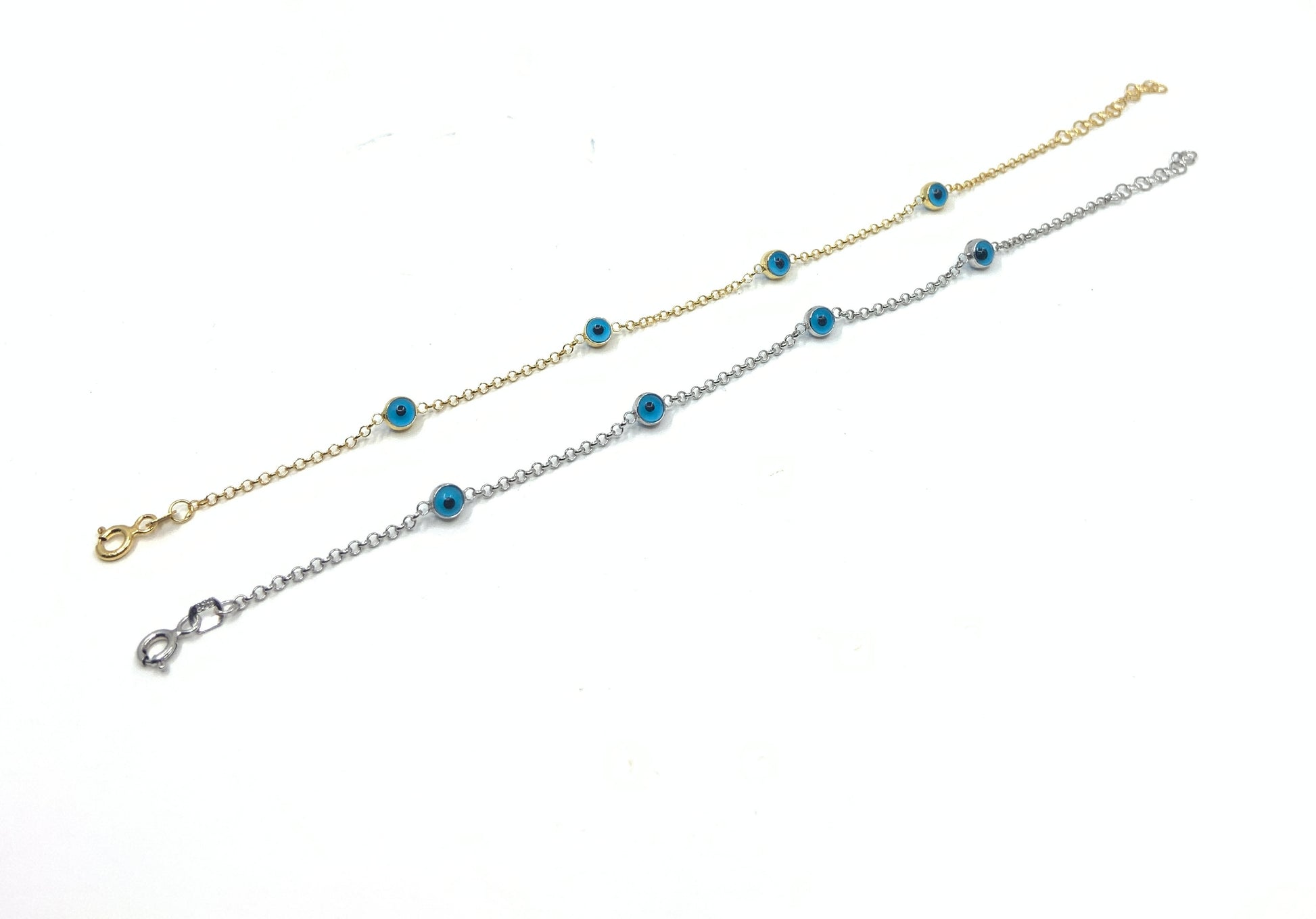 Murano Glass Evil eye stone silver and gold bracelets against a white background. 