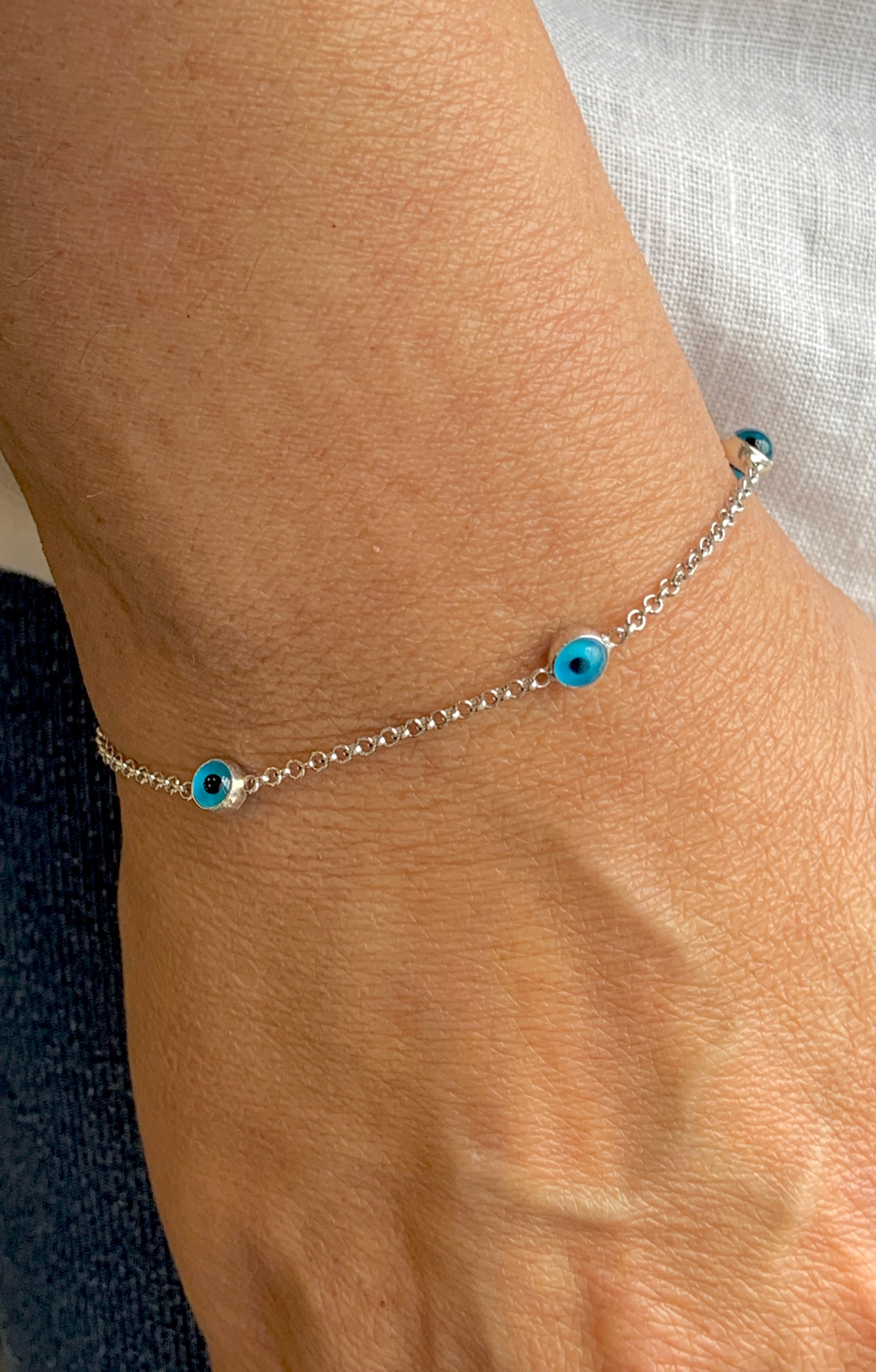 Murano Glass Evil eye stone silver bracelet worn on wrist 