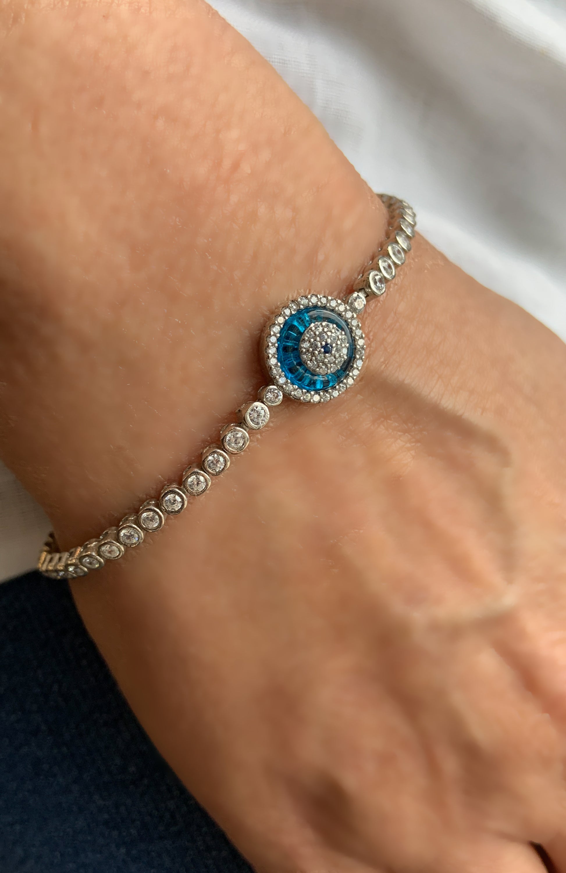 Blue Evil Eye Tennis Bracelet worn on wrist 