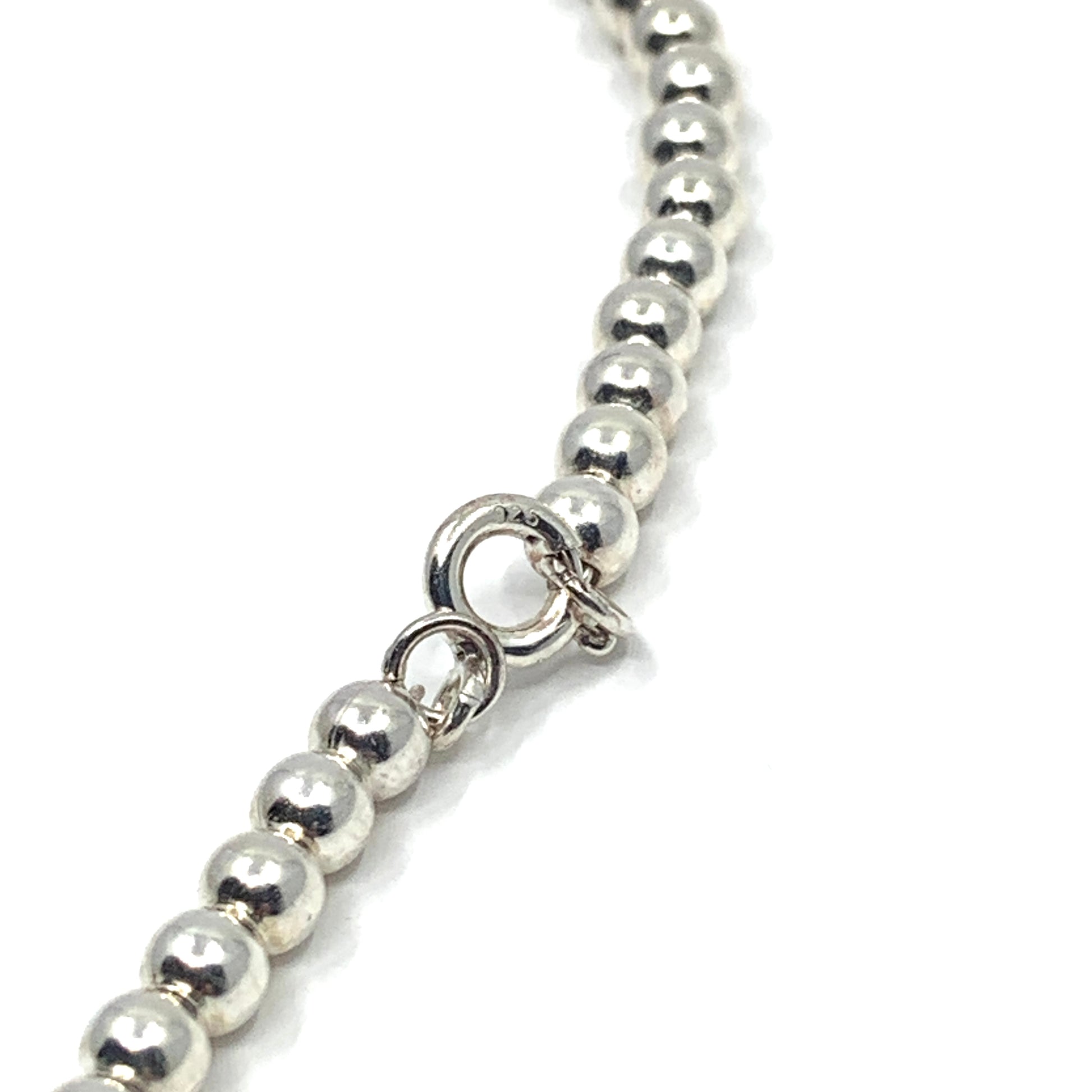 925 Stamp shown on the spring ring closure of sterling silver ball bead necklace.